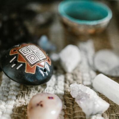 A variety of healing crystals and stones displayed on a textured mat, perfect for spiritual or meditation themes.